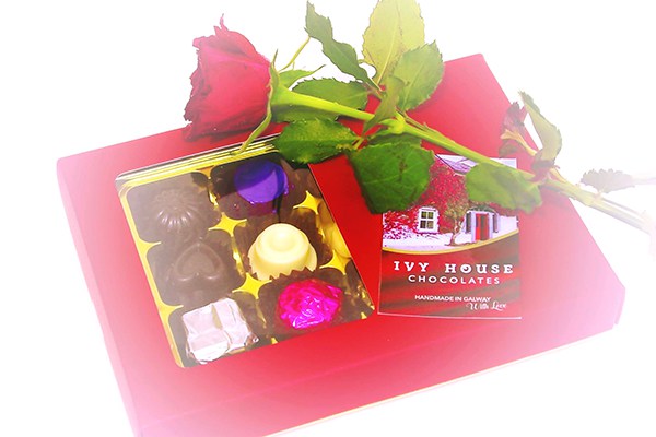 Ivy House Chocloates logo with decorative display of choclates and flowers