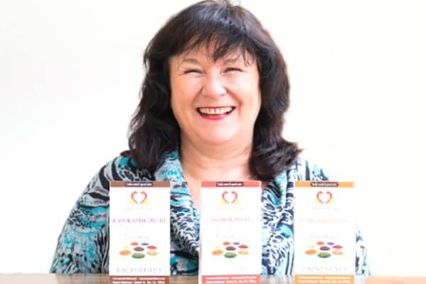Photo of owner with Spiced with Love product selection.