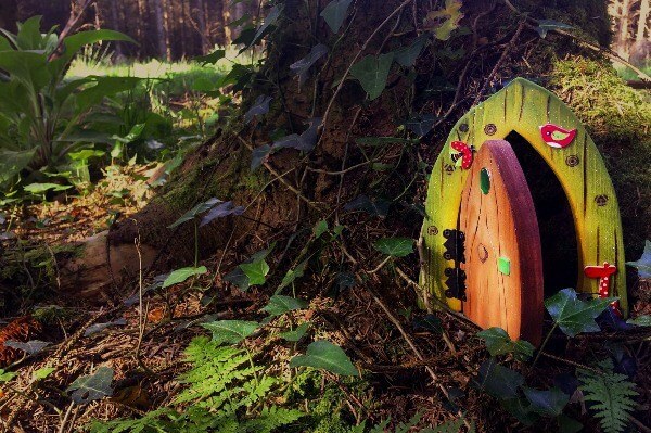 A Celtic Fairy Door at the foot of a tree in the woods.